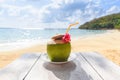 Coconut tropical fruit on table and sand beach background water - Fresh coconut juice summer with flower on beach sea in hot Royalty Free Stock Photo