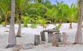 Coconut Tulum palm trees beach table and seats Royalty Free Stock Photo