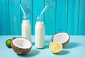 Coconut vegan milk coctail in bottle on blue background