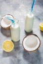 Coconut vegan milk coctail in bottle on concrete background