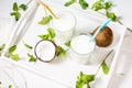 Coconut vegan milk coctail in glass on wooden background