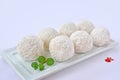 Coconut white chocolate balls on white serving plate