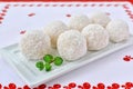 Coconut white chocolate candies on white serving plate