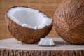 Coconut whole, half and piece on brown natural background