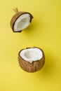 Coconut on yellow colored background, minimal flat lay style. Royalty Free Stock Photo