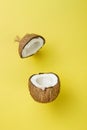 Coconut on yellow colored background, minimal flat lay style. Royalty Free Stock Photo