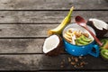 Coconut yogurt fruits with granola served on wooden table. Copy space. Probiotic food concept Tasty and healthy breakfast