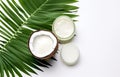 coconuts and coconut oil with tropical leaves onwhite bathroom background