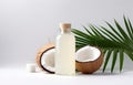 coconuts and coconut oil with tropical leaves onwhite bathroom background