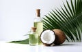 coconuts and coconut oil with tropical leaves onwhite bathroom background