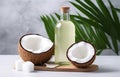 coconuts and coconut oil with tropical leaves onwhite bathroom background