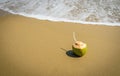 Coconuts with drinking straw on the sand