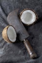 Coconuts and knife on dark background. Vertical photo. Royalty Free Stock Photo