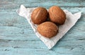 Coconuts. Three coconuts on white paper on a turquoise wooden background. Royalty Free Stock Photo
