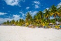 Cocos beach bar on a beach with white sand and palms on a sunny day, Isla Mujeres island, Caribbean Sea, Cancun, Yucatan, Mexico Royalty Free Stock Photo