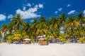 Cocos beach bar on a beach with white sand and palms on a sunny day, Isla Mujeres island, Caribbean Sea, Cancun, Yucatan, Mexico Royalty Free Stock Photo