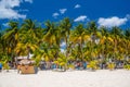 Cocos beach bar on a beach with white sand and palms on a sunny day, Isla Mujeres island, Caribbean Sea, Cancun, Yucatan, Mexico Royalty Free Stock Photo