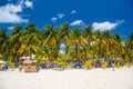 Cocos beach bar on a beach with white sand and palms on a sunny day, Isla Mujeres island, Caribbean Sea, Cancun, Yucatan, Mexico Royalty Free Stock Photo