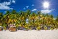 Cocos beach bar on a beach with white sand and palms on a sunny day, Isla Mujeres island, Caribbean Sea, Cancun, Yucatan, Mexico Royalty Free Stock Photo