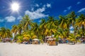 Cocos beach bar on a beach with white sand and palms on a sunny day, Isla Mujeres island, Caribbean Sea, Cancun, Yucatan, Mexico Royalty Free Stock Photo