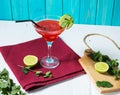 Coctail margarita with lime on blue wood background