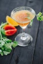 Coctail with orange and tomato on black wooden table at blurred background Royalty Free Stock Photo