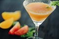 Coctail with orange and tomato on black wooden table at blurred background Royalty Free Stock Photo