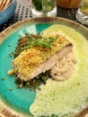 cod fillet in breadcrumbs, crispy breading on fish fillet, lentils, celery puree, parsley sauce, dinner in a restaurant, cod Royalty Free Stock Photo