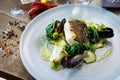 Cod fillet with cauliflower cream, asparagus, clam-wine sauce and mussles. Delicious seafood fish closeup served on a Royalty Free Stock Photo