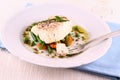 Cod fillet on fork with green beans, peas, parsley, olive oil Royalty Free Stock Photo