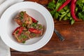 Cod fillet or other fish on a white plate. Braised in tomato and onion. Peas are sprinkled with green leaves and microgreen from Royalty Free Stock Photo