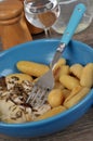 Cod fillet and potatoes served on a blue plate