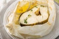 Cod fillets baked in parchment paper with slices