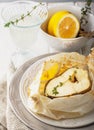 Cod fillets baked in parchment paper with slices