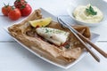 Cod fillets baked in parchment paper with vegetables