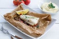 Cod fillets baked in parchment paper with vegetables