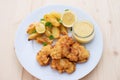 Cod fish in batter or cod fritters served with baked potatoes with parsley leaves and home made mayonnaise sauce. Royalty Free Stock Photo