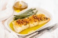 Cod fish with corn bread and green beans on dish Royalty Free Stock Photo