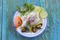 Cod fish fillet, Atlantic cod with seafood mussells,shrimps,lime and vegetable, on blue wooden background Royalty Free Stock Photo