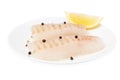 Cod fish raw pieces on the plate spiced with salt and peppercorns, isolated on white background Royalty Free Stock Photo
