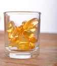 Cod liver fish oil omega 3 gel capsules in glass