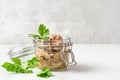 Cod liver in a jar with parsley. Natural source of omega 3 and vitamin D. close up