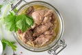 Cod liver in a jar with parsley. Natural source of omega 3 and vitamin D. top view
