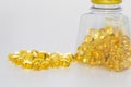 Cod liver oil capsules bottle with some spilled over Royalty Free Stock Photo