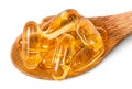 Cod liver oil omega 3 capsules on wooden spoon Royalty Free Stock Photo