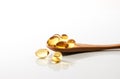 Cod liver oil omega 3 gel capsules in a wooden spoon Royalty Free Stock Photo