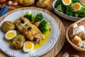 Cod loin baked in olive oil, with potatoes, broccoli, boiled egg and black olives. Typical dish of Portugal Royalty Free Stock Photo