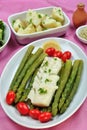 Cod loins with green asparagus and tomato Royalty Free Stock Photo