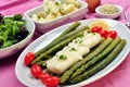 Cod loins with green asparagus and tomato Royalty Free Stock Photo