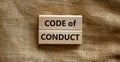 Code of conduct symbol. Concept words `Code of conduct` on wooden blocks on a beautiful canvas background. Business and code of